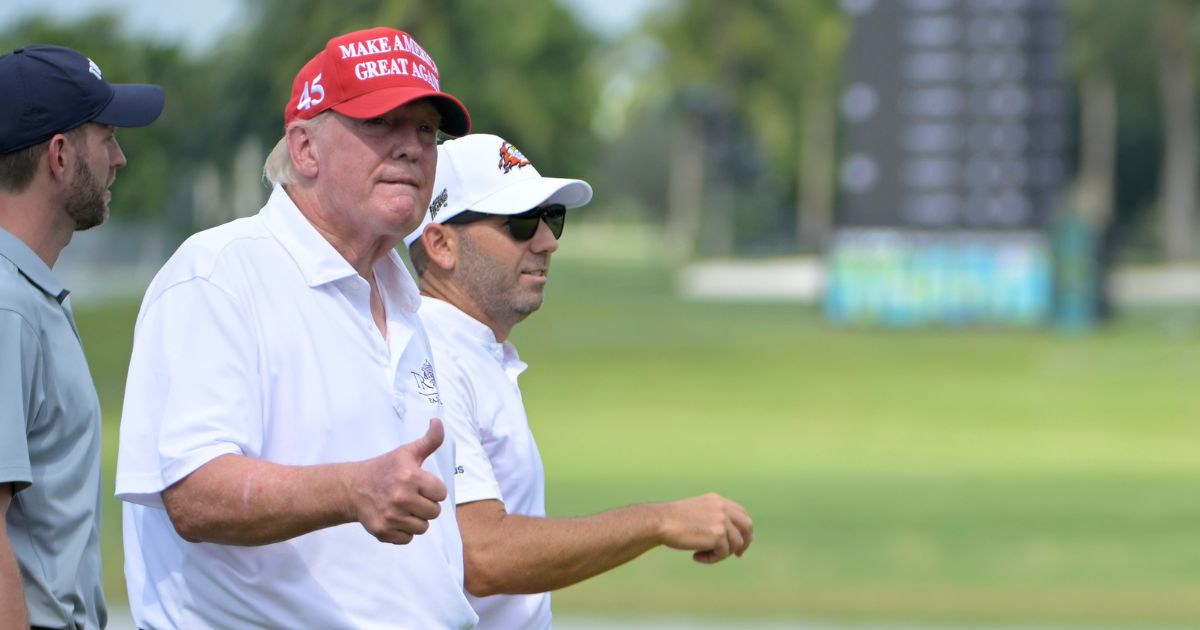 Former President Donald Trump and Team Captain Sergio Garcia of Fireballs GC are seen on the 18th green during a pro-am prior to the LIV Golf Invitational - Miami at Trump National Doral Miami on Thursday in Doral, Florida.