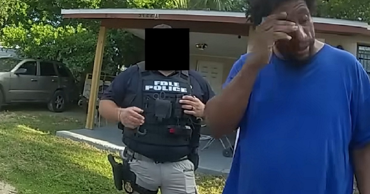 A still from a police bodycam shows a Florida man reacting to news that he had a warrant for his arrest for suspected voter fraud.