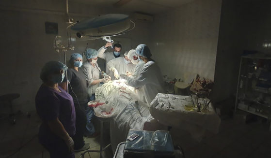 This photo made available by Ukrainian doctor Oleh Duda shows the moment when lights at a hospital went out as he was performing complicated, dangerous surgery on a bleeding patient at a hospital in Lviv, Ukraine, on Nov. 15.