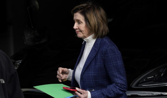 House Speaker Nancy Pelosi is escorted to a vehicle outside of her home in San Francisco, California on Friday.