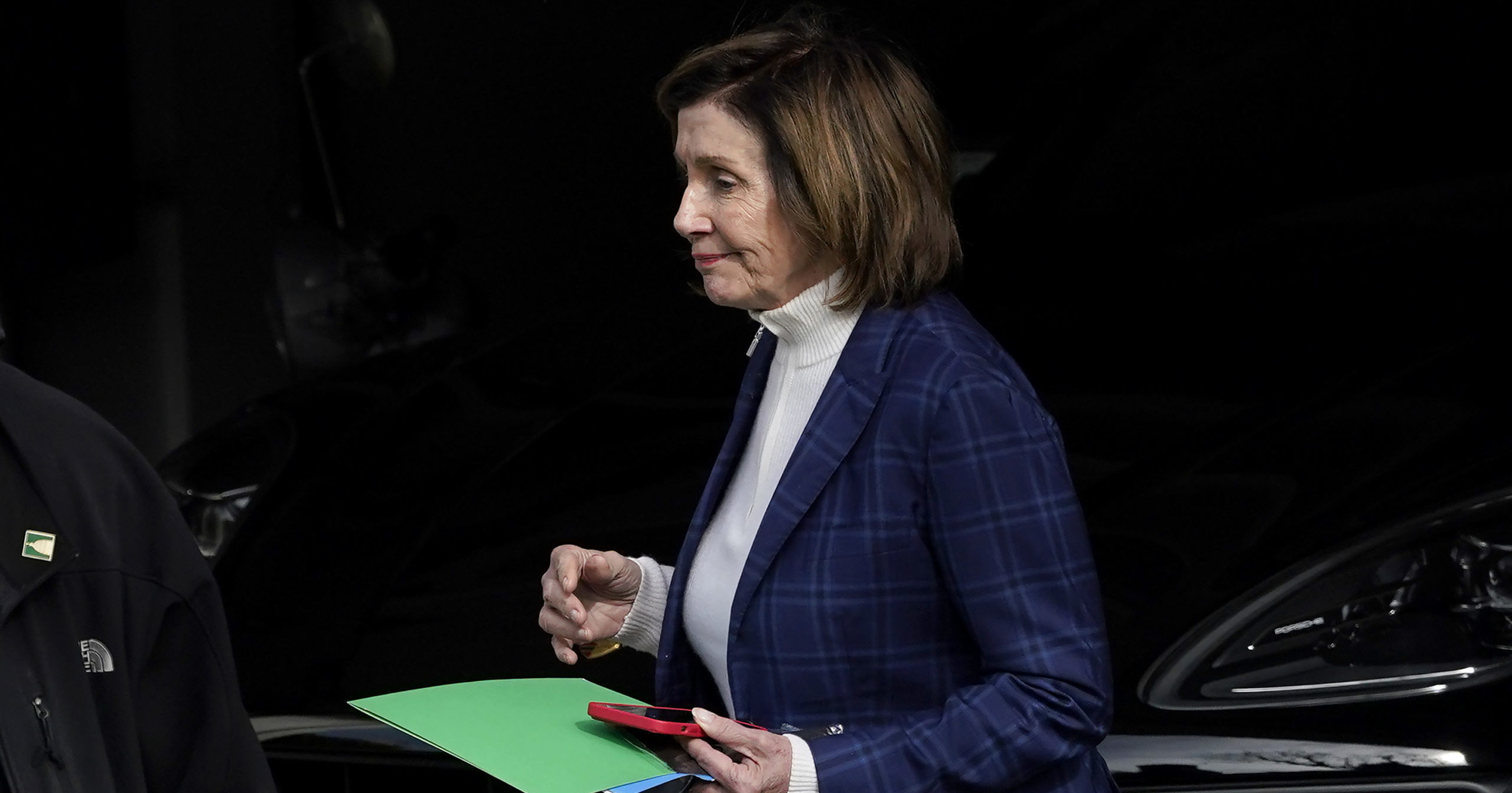 House Speaker Nancy Pelosi is escorted to a vehicle outside of her home in San Francisco, California on Friday.