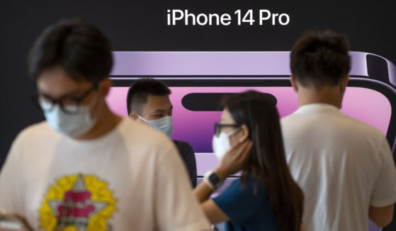 Customers shop at an Apple Store on the first day of sale for the Apple iPhone 14 in Beijing, China on September 16.