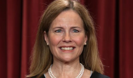 U.S. Supreme Court Associate Justice Amy Coney Barrett poses for her official portrait in the Supreme Court building on Oct. 7.