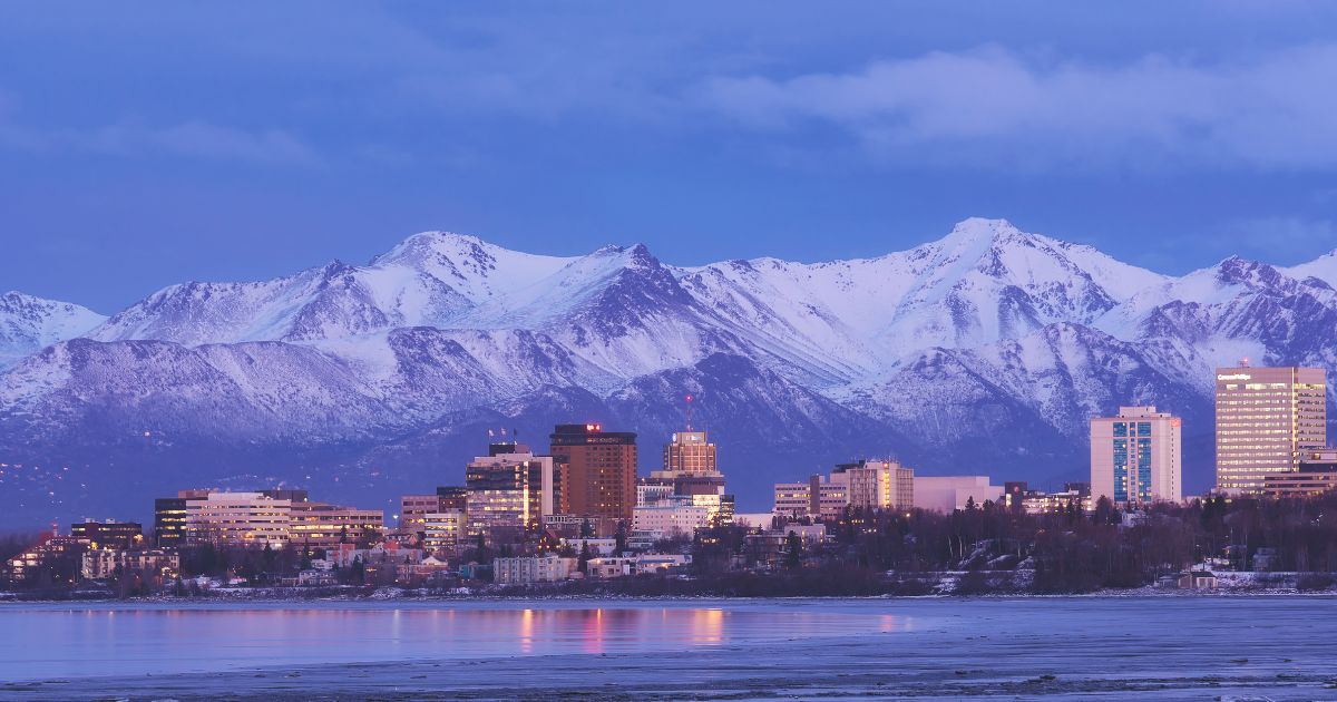 The skyline of Anchorage, Alaska, is pictured with the mountains in background.