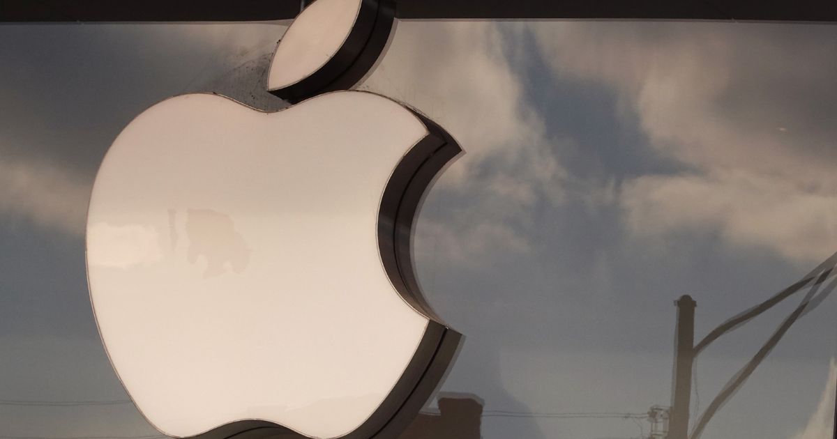 The Apple company logo hangs above an Apple retail store in Chicago, Illinois, on Monday.