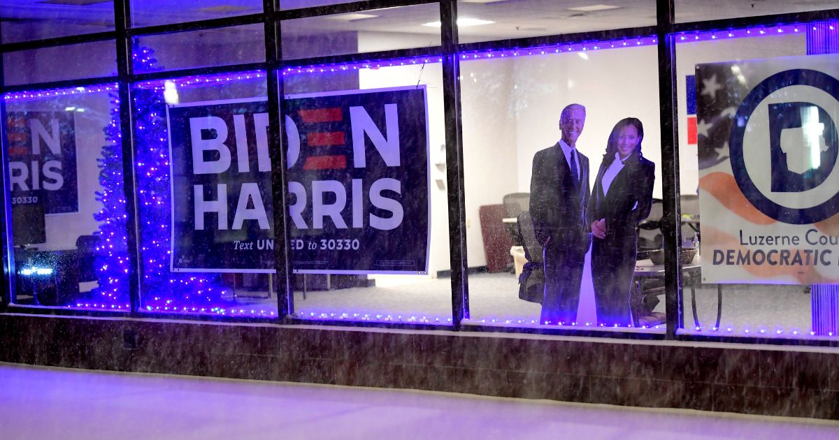 Cardboard cutouts of President-elect Joe Biden and Vice President-elect Kamala Harris are placed by the window of the Luzerne County Democratic headquarters during heavy snowfall on December 16, 2020 in Wilkes Barre, Pennsylvania.