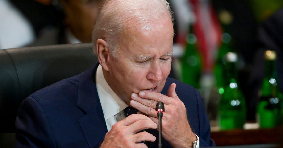 President Joe Biden touches his mouth during a working session on energy and food security at the Group of 20 summit in Bali, Indonesia, on Tuesday.