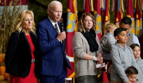 President Joe Biden speaks while first lady Jill Biden and a military family stand on stage with him during a "Friendsgiving" event at Marine Corps Air Station Cherry Point in Havelock, North Carolina, on Monday.