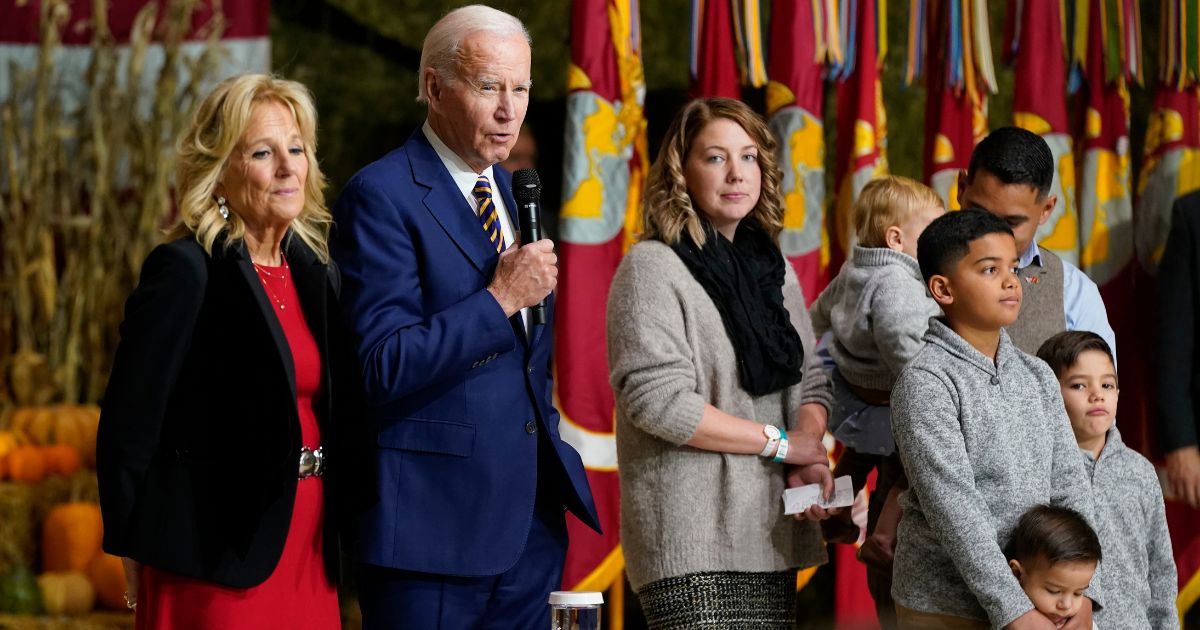 President Joe Biden speaks while first lady Jill Biden and a military family stand on stage with him during a "Friendsgiving" event at Marine Corps Air Station Cherry Point in Havelock, North Carolina, on Monday.