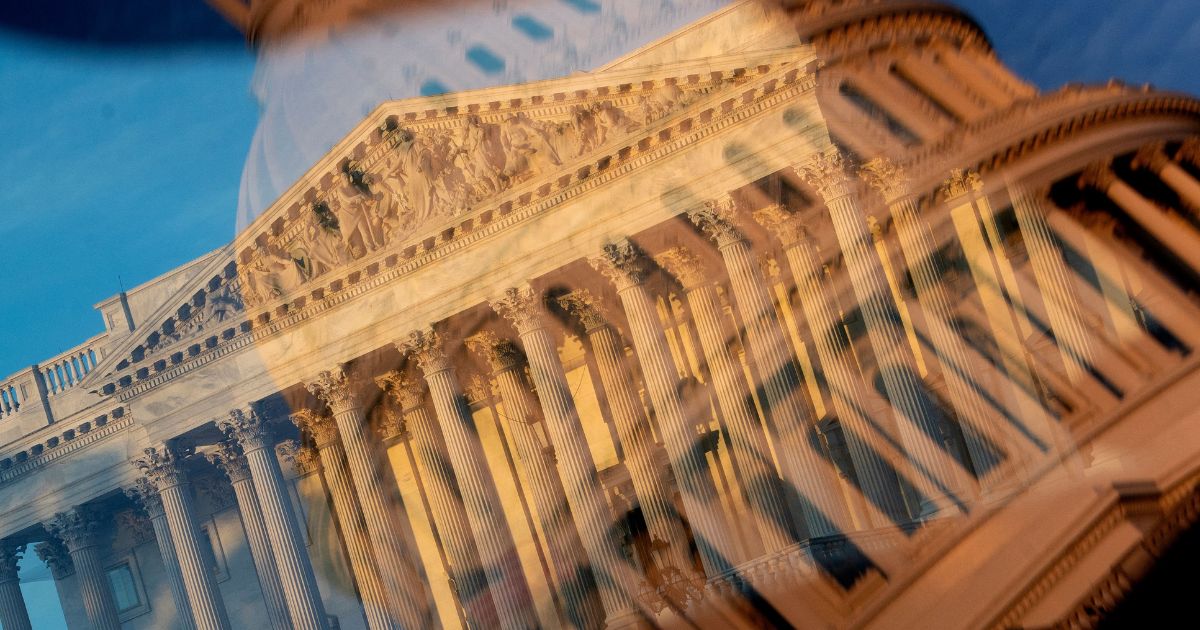 The Supreme Court is seen through a reflection of the U.S. Capitol dome in Washington, D.C., on Tuesday.
