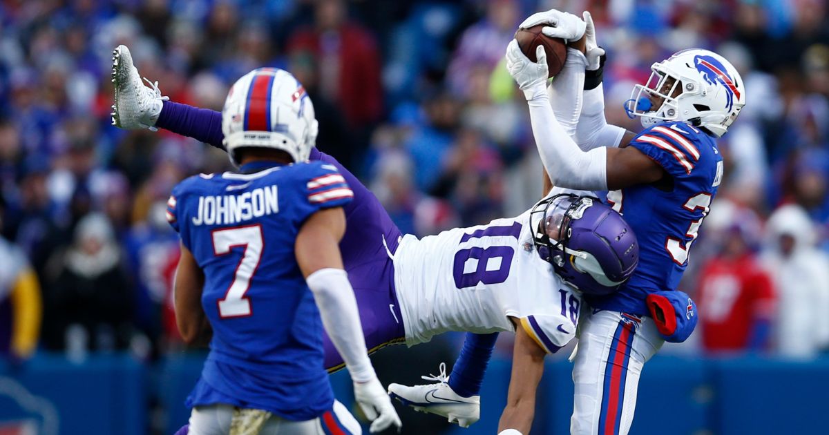 Minnesota wide receiver Justin Jefferson and Bills cornerback Cam Lewis fight for the ball on a fourth-and-18 pass in the fourth quarter Sunday at Highmark Stadium in Orchard Park, New York. Jefferson came away with the ball, and Minnesota beat Buffalo 33-30 in overtime.