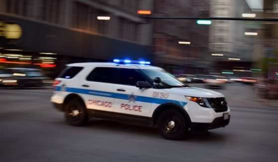 A Chicago police vehicle speeds through an intersection.