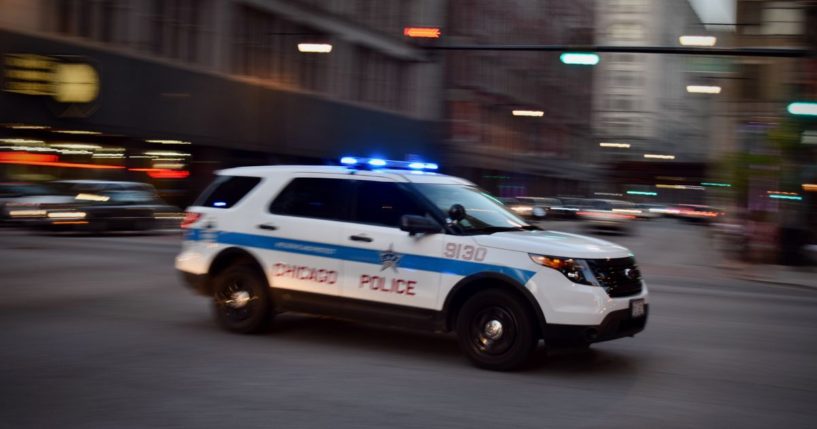 A Chicago police vehicle speeds through an intersection.