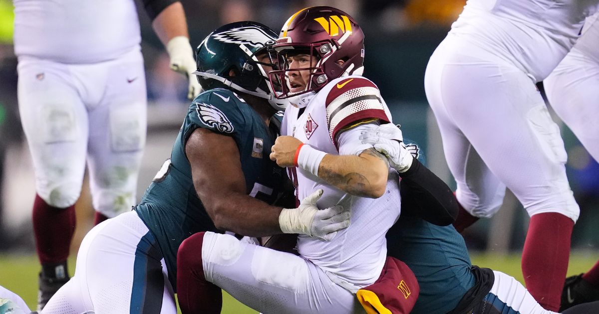 Brandon Graham of the Philadelphia Eagles hits Taylor Heinicke of the Washington Commanders in the fourth quarter of their game at Lincoln Financial Field in Philadelphia on Monday night.
