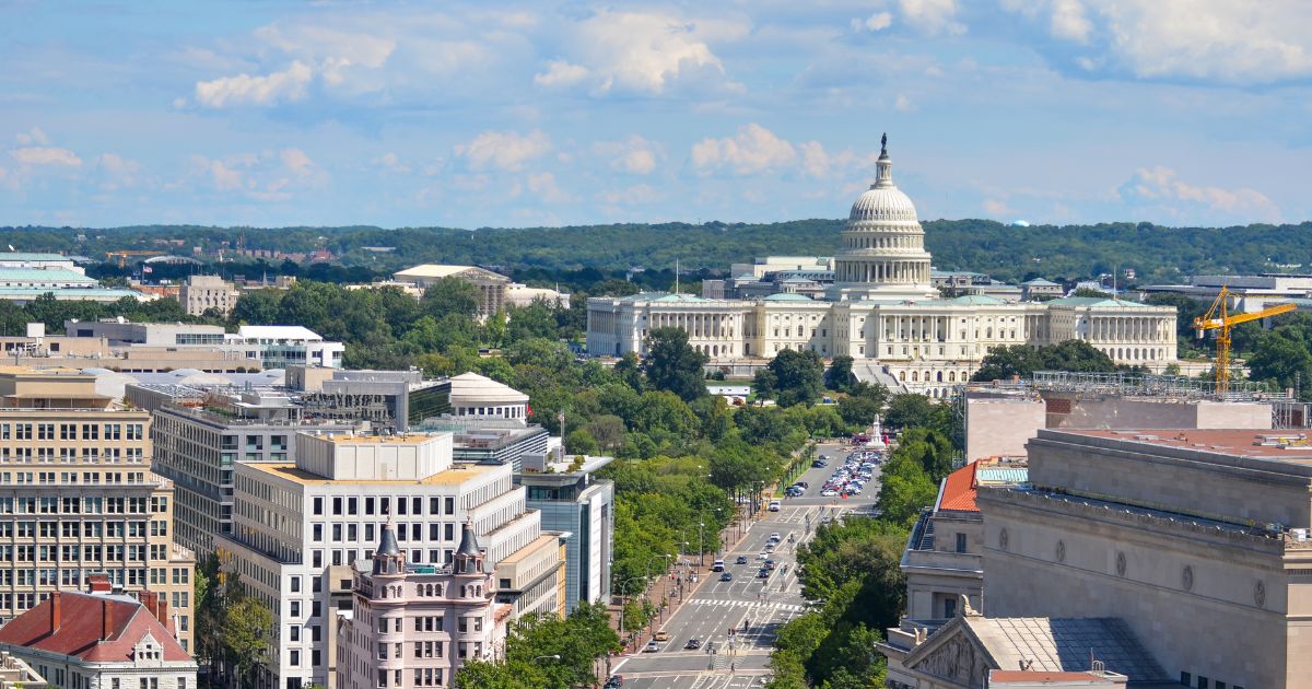 An aerial view of Pennsylvania Avenue in Washington, D.C., shows several U.S. government buildings, including the Department of Justice and the Capitol.