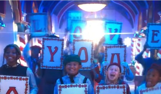 Signs spelling out "We Love You Satan" are seen in Disney's "The Santa Clauses."