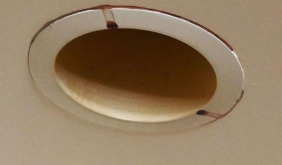 Dried blood crusts around a light fixture in a Harlem apartment.
