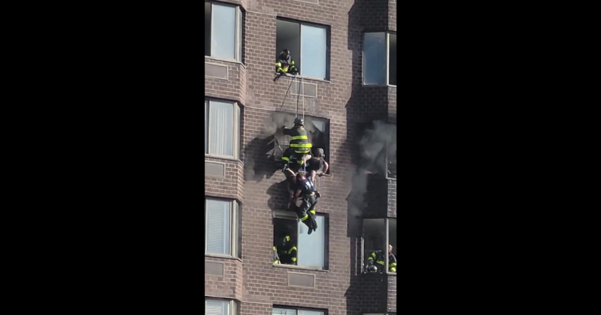 New York firefighters perform a daring rescue after a large fire breaks out in Manhattan.