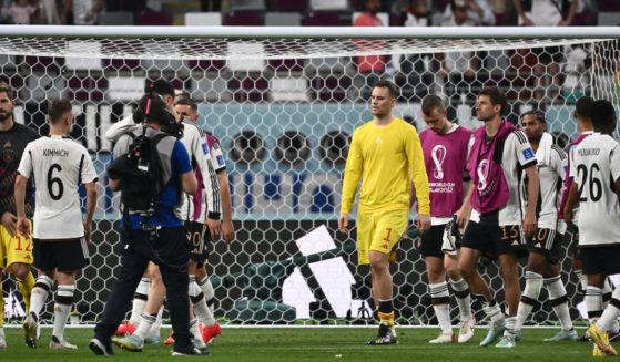 German goalkeeper Manuel Neuer, center, and his teammates react after losing 2-1 to Japan in the World Cup Group E football match at the Khalifa International Stadium in Doha, Qatar, on Wednesday.