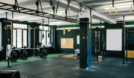 This stock photo shows an empty gym with equipment ready for use.