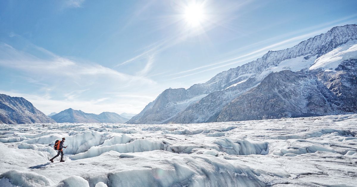 A hiker walks on a glacier in Switzerland in this stock image.