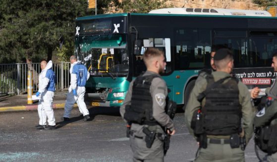 Israeli security forces and forensic experts work at the scene of an explosion at a bus stop in Jerusalem on Wednesday.