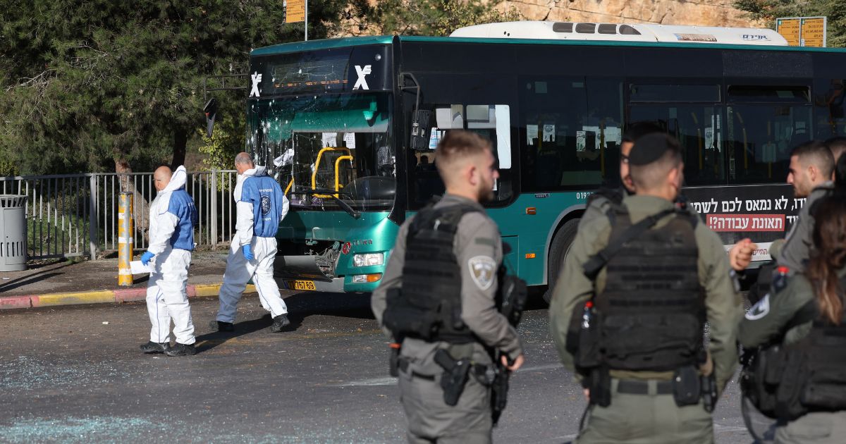Israeli security forces and forensic experts work at the scene of an explosion at a bus stop in Jerusalem on Wednesday.