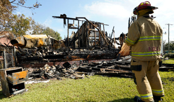 A firefighter observes the remains of a burned Epiphany Lutheran Church near midtown Jackson, Mississippi, on Tuesday.