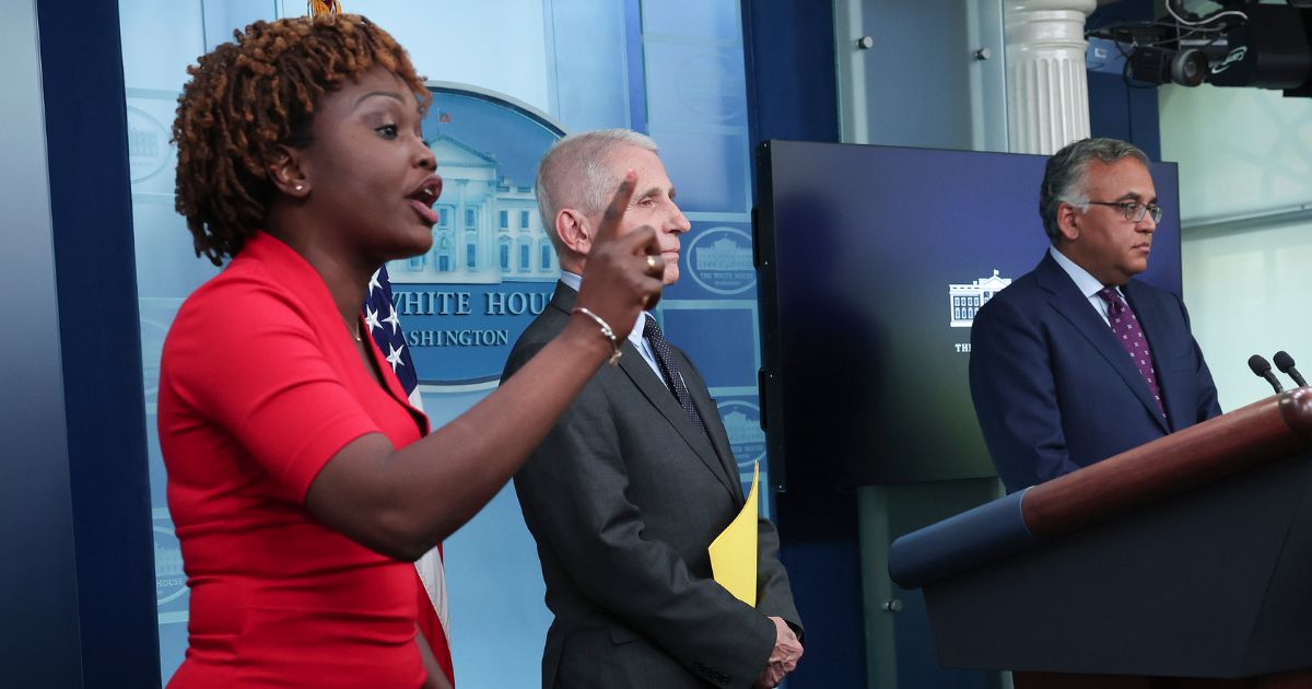 White House press secretary Karine Jean-Pierre, left, talks back to a reporter over his defense of a reporter's question to Dr. Anthony Fauci, middle, during a briefing on COVID at the White House on Tuesday.