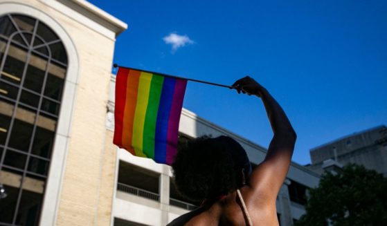 A person waves a rainbow flag on June 25 in Raleigh, North Carolina.
