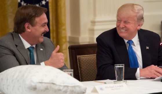 MyPillow founder Mike Lindell, left, speaks with then-President Donald Trump during an event with American manufacturers in the East Room of the White House in Washington on July 19, 2017.