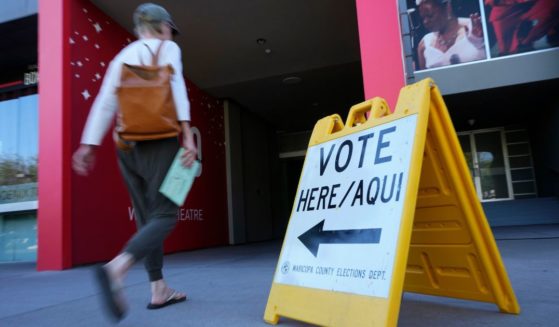 A voter arrives to cast her ballot at the Phoenix Art Museum in Phoenix on Tuesday.