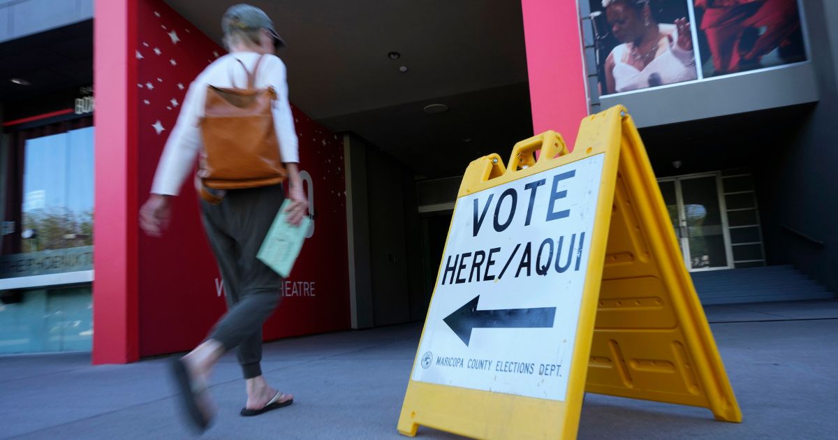 A voter arrives to cast her ballot at the Phoenix Art Museum in Phoenix on Tuesday.