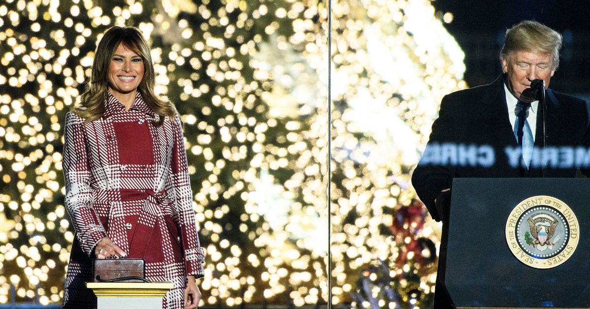 President Donald Trump speaks as first lady Melania Trump lights a tree during the Christmas tree lighting on the National Mall on Dec.5, 2019.