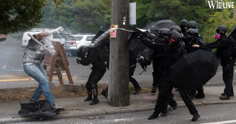 Antifa activists spray a member of the Proud Boys during an altercation in Portland, Oregon, on Aug. 22, 2021.