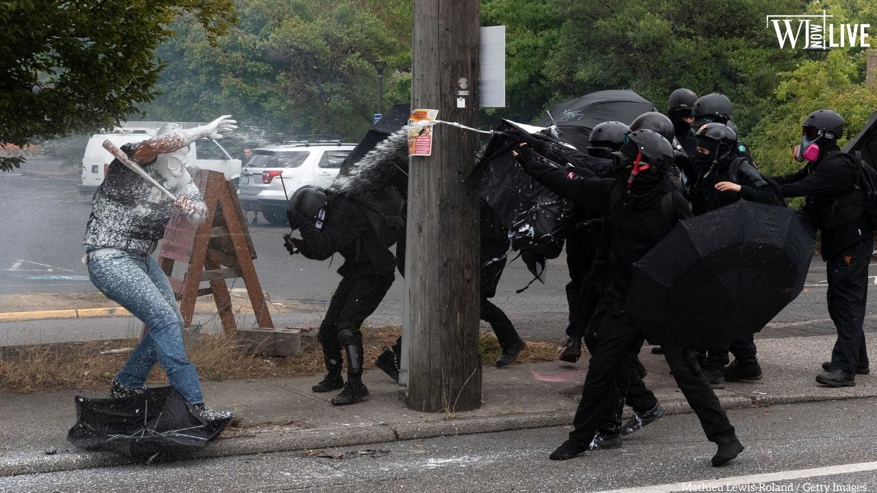 Antifa activists spray a member of the Proud Boys during an altercation in Portland, Oregon, on Aug. 22, 2021.