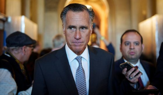 Utah GOP Sen. Mitt Romney leaves the Senate floor after voting yes on a procedural vote on federal legislation protecting same-sex marriages Wednesday at the U.S. Capitol.