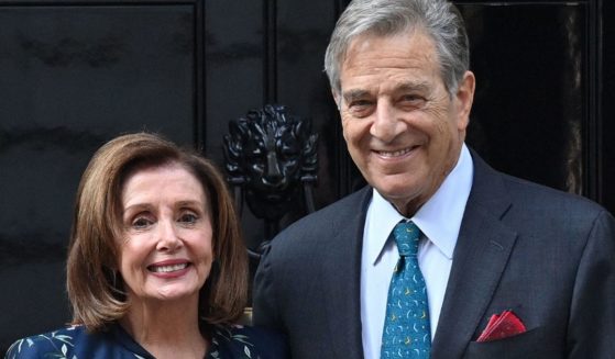 Speaker of the House Nancy Pelosi and her husband, Paul Pelosi, stand outside the British prime minister's office at 10 Downing St. in central London on Sept. 16, 2021.