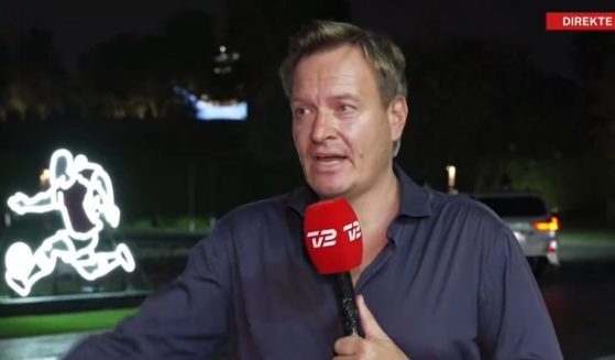 Rasmus Tantholdt of Denmark's TV2 is interrupted by Qatari authorities during a Tuesday broadcast from the capital city of Doha.