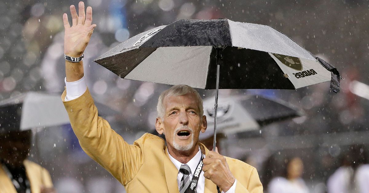 Former Oakland Raiders punter Ray Guy waves during a ceremony honoring his induction into the Pro Football Hall of Fame during halftime of a game between the Raiders and the Kansas City Chiefs in Oakland on Nov. 20, 2014.