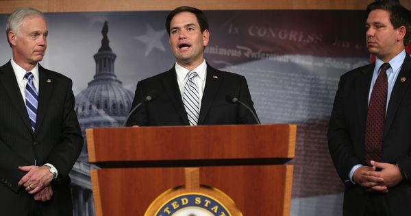 Sen. Marco Rubio, center, speaks to the media in Washington, D.C., with Sen. Ron Johnson, left, and then-Rep. Ron DeSantis, right, on Oct. 30, 2013.