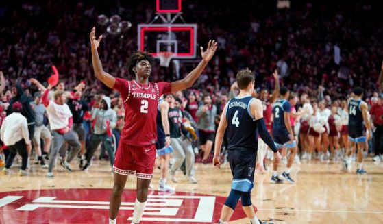 Temple's Jahlil White, left, celebrates after Temple won an NCAA college basketball game against Villanova on Friday in Philadelphia.