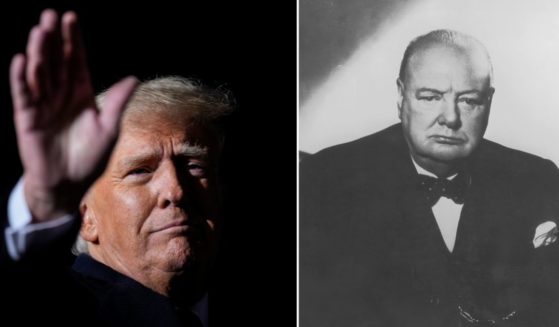 Former U.S. President Donald Trump waves at a rally on Monday in Vandalia, Ohio. British Prime Minister Winston Churchill sits in an armchair.