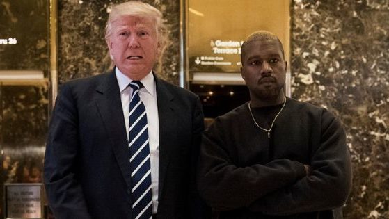 Then-President-elect Donald Trump, left, and Kanye West, right, stand together in the lobby at Trump Tower in New York City on Dec. 13, 2016.