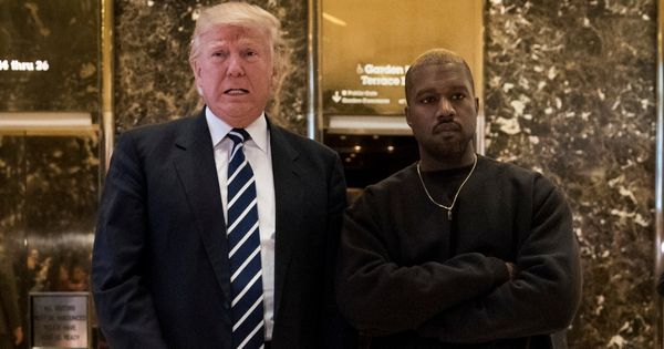 Then-President-elect Donald Trump, left, and Kanye West, right, stand together in the lobby at Trump Tower in New York City on Dec. 13, 2016.