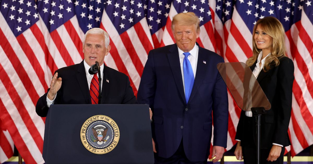 Vice President Mike Pence speaks as U.S. President Donald Trump and first lady Melania Trump watch on election night in the East Room of the White House in the early morning hours of November 04, 2020 in Washington, DC.
