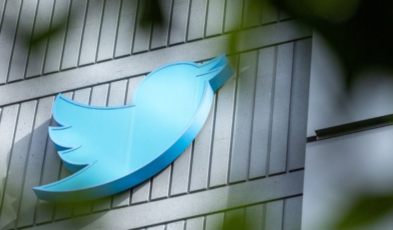 The Twitter logo is seen on a sign on the exterior of Twitter headquarters in San Francisco on Friday.