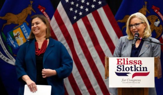 U.S. Rep. Liz Cheney (right), a Republican from Wyoming, and Rep. Elissa Slotkin, D-Mich., smile as Cheney offers her support during a campaign rally Tuesday in East Lansing, Mich. Also this week, Cheney has praised Democratic House Speaker Nancy Pelosi.