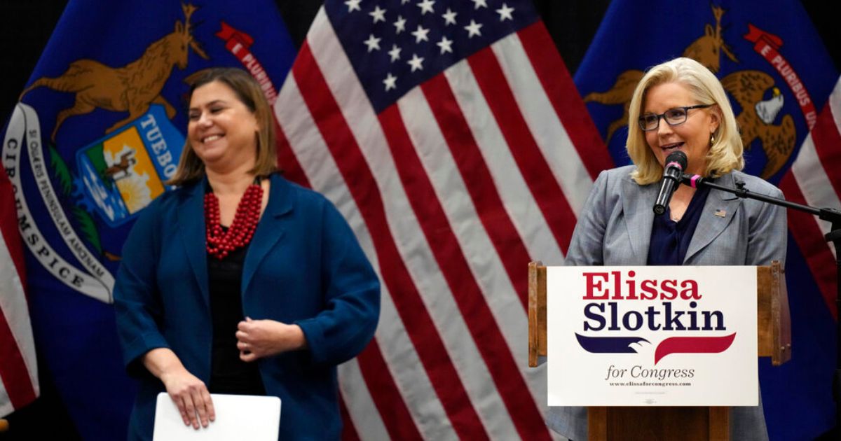 U.S. Rep. Liz Cheney (right), a Republican from Wyoming, and Rep. Elissa Slotkin, D-Mich., smile as Cheney offers her support during a campaign rally Tuesday in East Lansing, Mich. Also this week, Cheney has praised Democratic House Speaker Nancy Pelosi.