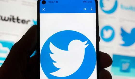 The Twitter logo is seen on a cell phone in Boston on Oct. 14.
